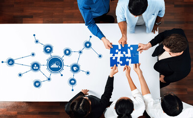 Aufkleber - A top-down view of a business team collaboratively solving a puzzle on a table, surrounded by data icons and graphic elements representing management strategies. Amity