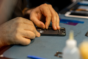 Aufkleber - Expert Technician Repairing Phone at a Workspace With Tools and Components in a Well-Lit Environment