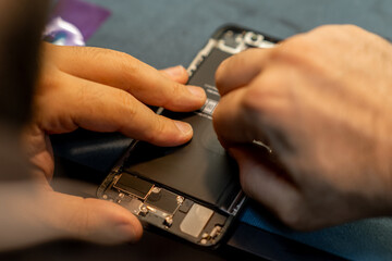 Aufkleber - Phone Repair Technician Replacing Battery in Smartphone Inside Workshop During Daylight Hours