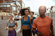 © Marko Geber - Diverse group of young people running together in the city