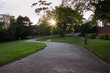 © Austockphoto - Curving Garden Path with Sun Setting in Background