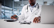 © Andrey Popov - African-American Doctor Calculating Tax Invoice