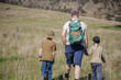 © Austockphoto - Dad and two young sons bushwalking through a paddock