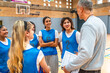 © unai - Basketball coach explaining strategy to female high school team
