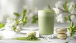 © Andi - Green tea latte with matcha powder and macarons.