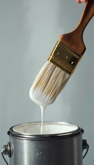 Poster - Close-up of paintbrush dripping white paint into can indoors