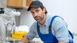 © Nataliia_Trushchenko - Man in a blue work vest is standing in front of a sink. He is wearing a black hat and has a serious expression on his face