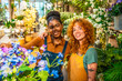 © unai - Two young florists smiling and posing in their flower shop