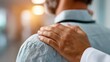 © Yevheniiya - Close-up view of a person's shoulder with a supportive hand resting on it, offering comfort.