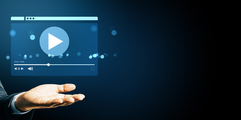 Poster - Business hand showing floating video player interface icon on dark blue background with bokeh light, symbolizing streaming service concept.
