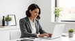 © Pixel With MH - Smiling businesswoman working on laptop in modern office
