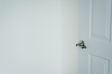 Poster - White Wall with Open Door and Modern Door Handle in Minimalist Interior Setting