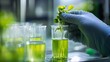 © 9BEi - Scientist's Hand Gently Placing a Plant Cutting into a Beaker of Green Liquid in a Laboratory Setting