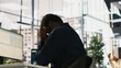 © DC Studio - Worker feeling painful headache while working, suffering burnout while rushing to finish tasks before deadline. African american man in office having migraine after working overtime, camera A