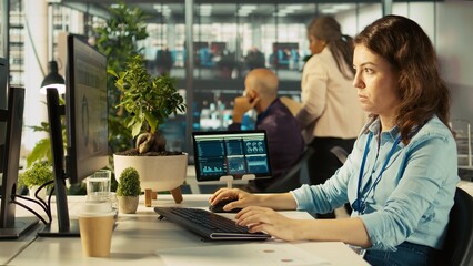 Poster - Close up of woman sitting at office desk, solving tasks during job shift. Office clerk doing email communication in workplace, researching data for company project, camera B