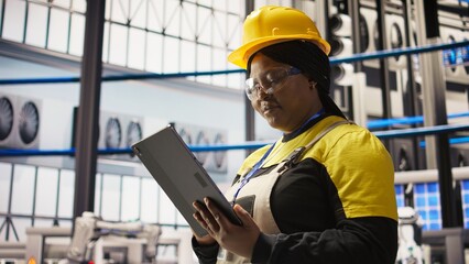 Poster - Solar panels plant expert uses tablet to oversee systems, ensuring machinery operates at optimal efficiency. Photovoltaics plant employee uses device software to maintain operations, camera A close up