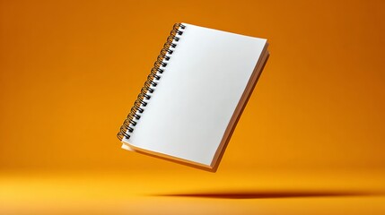 Poster - Spiral bound notebook is floating in the air on a yellow background