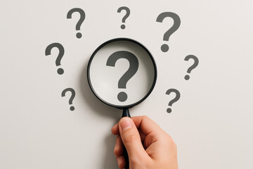 Poster - Exploring uncertainty and inquiry a holds a magnifying glass focusing on a question mark symbolizing investigation and analysis in problem solving
