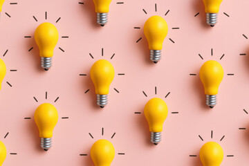 Poster - Multiple glowing yellow light bulbs evenly arranged on a soft pink background symbolize innovation and bright ideas in business strategy