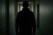 © George - Shadows and mystery fill the hallway as a lone figure stands in contemplation during an eerie encounter