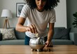 © FAWF STUDIO - Person putting coins into a piggy bank, symbolizing savings and financial planning