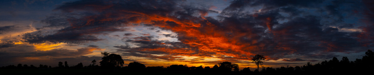 Wall Mural - panorama sunlight with dramatic sky on dark background.vivid sky on dark cloud.