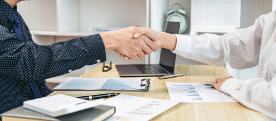 Poster - Two people shaking hands in a business setting