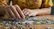 © Naru - Woman Solving Colorful Jigsaw Puzzle - Close-up of hands carefully placing puzzle pieces, showcasing focus and concentration during a leisure activity