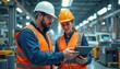 © miss irine - Male engineer female product designer discuss work at car assembly plant using tablet. Industrial specialists working on vehicle design, quality control, tech factory.
