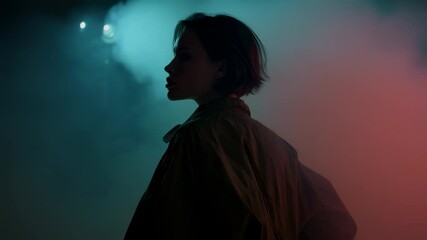 Poster - Fashion model standing in profile, bathed in shifting colored lights and swirling smoke, creating dramatic visual narrative with stylized artistic expression and intense atmospheric mood