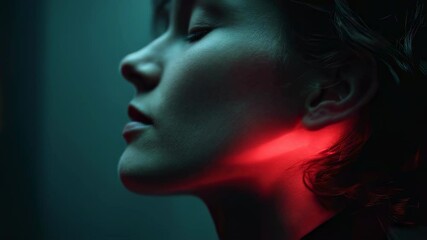 Poster - Red light dramatically illuminating woman's neck in profile, casting deep shadows and creating intense artistic mood against dark, minimalist background with glowing, elegant aesthetic