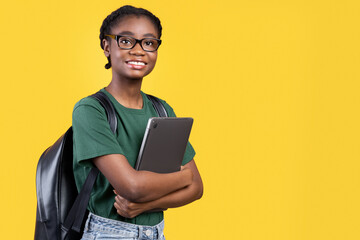 Aufkleber - Smiling African Female Student Holding Laptop Hugging Computer Posing Standing On Yellow Studio Background. E-Learning And Educational Gadgets, Distant Online Study And Student's Lifestyle Concept
