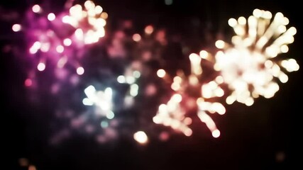 Blurred Colorful Fireworks Exploding in Night Sky on Black Background
