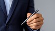 © santima - Business professional holding a pen in hand.