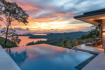 Wall Mural - Luxury infinity pool overlooking islands at dusk with bright orange sky. Perfect for travel ads, real estate promotions, or vacation planning.