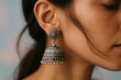© Yash - Closeup of traditional silver jhumka earrings on Indian woman, ethnic jewelry and style