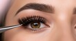 © NeuroCake - Applying false eyelash extensions with tweezers. Macro beauty close up. Lash extension service and beauty treatment concept. Image for banner, poster, wallpaper and advertisement