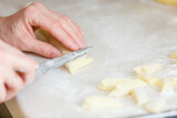 Hands making noodles