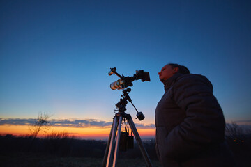 Canvas Print - amateur astronomer using telescope for watching stars, moon, planets and other celestial objects fro