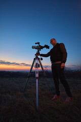 Canvas Print - amateur astronomer using telescope and smartphone for watching stars, moon, planets and other celest