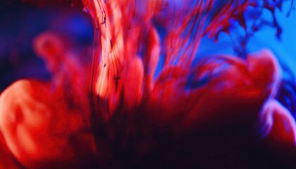 Poster -  vibrant red ink swirling in blue liquid abstract background for web design, print media, and branding with fluid motion and dramatic color contrast