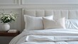 © Abstract - A neatly folded stack of fresh white sheets and pillowcases on a comfortable bed with a natural wood headboard, creating a clean, cozy, and relaxing bedroom scene
