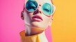 © Juan - Woman with blue sunglasses and yellow turtleneck on pink background for trendy fashion style scene