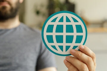 Poster - A man holds a teal world icon, symbolizing global connection and networking.