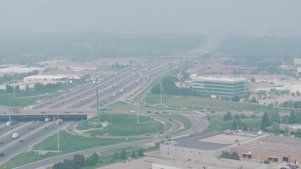Wall Mural - the highway in mississauga, ontario, canada, covered in smoky haze from wildfires, aerial view