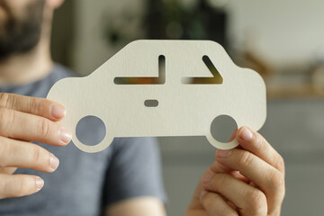 Aufkleber - Image of a person holding a paper car cutout, ideal for auto insurance, car buying, or transportation themes.