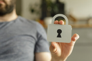 Poster - Image depicting data security, privacy, and protection. A person holds a paper cutout of a padlock.