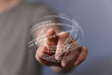 Poster - Close-up of hand interacting with a transparent sphere of digital code, representing data visualization and technology.