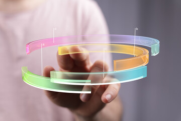 Poster - Person interacts with a colorful 3D chart, showcasing data analysis and technology.