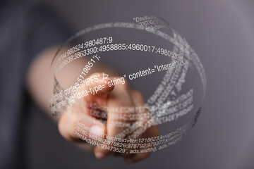 Aufkleber - Close-up of a hand interacting with a digital holographic display showing lines of code.
